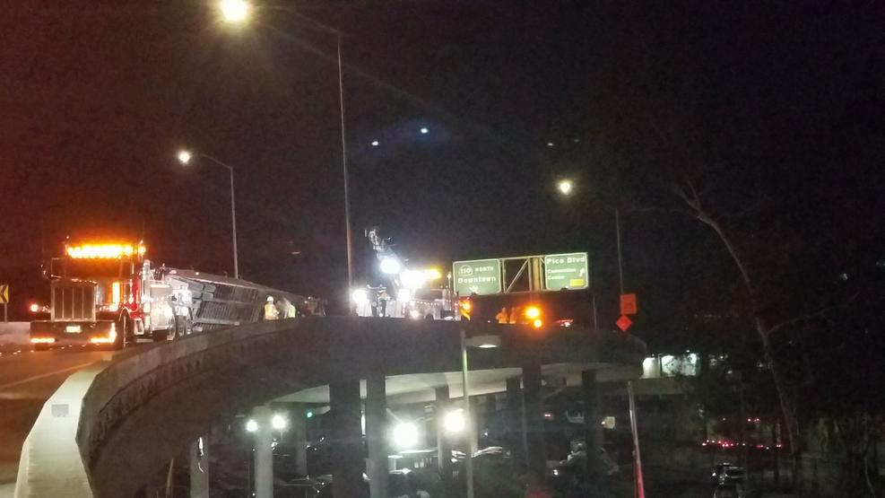 Trash Spills From Overturned Truck on Freeway Transition Near Downtown Los Angeles