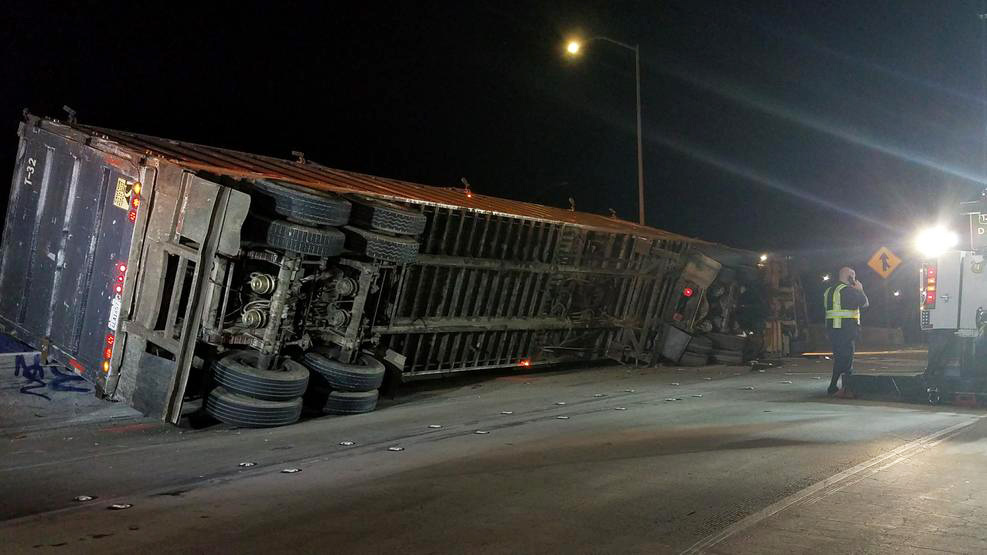 Trash Spills From Overturned Truck on Freeway Transition Near Downtown Los Angeles