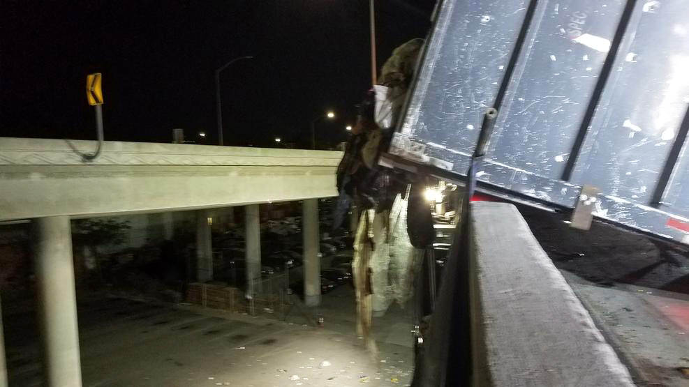 Trash Spills From Overturned Truck on Freeway Transition Near Downtown Los Angeles